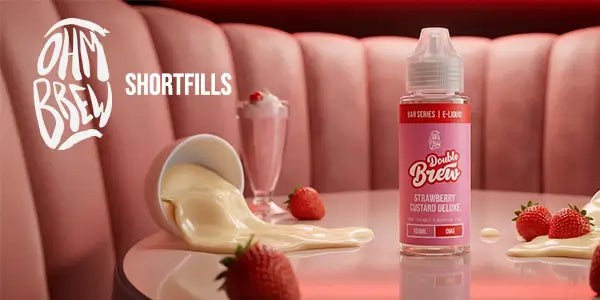 Double Brew Strawberry Custard Deluxe shortfill bottle on a table with pink booth background