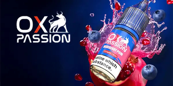 OX Passion Blueberry Pom nicotine salt e-liquid bottle (10ml) featuring a splash of blueberries and pomegranate seeds on a blue background.