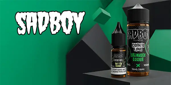 Two bottles of Sadboy vape juice on a green and black geometric background with 'Sadboy' branding.