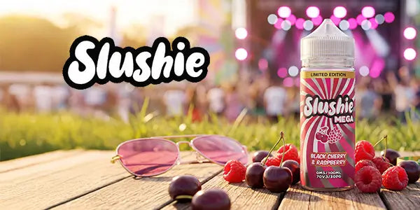 Slushie vape juice bottle with cherries and sunglasses on a wooden table at a festival.