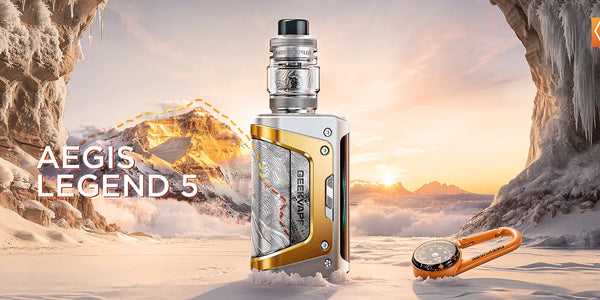 Geekvape Aegis Legend 5 sub-ohm kit in silver and gold with sub-ohm tank, set against a rugged mountain landscape.