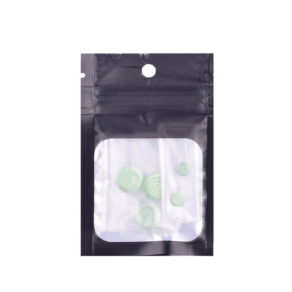 Green button kit in a clear plastic pouch with a black resealable top.