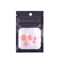 Orange button kit in a clear plastic pouch, displayed against a white background.