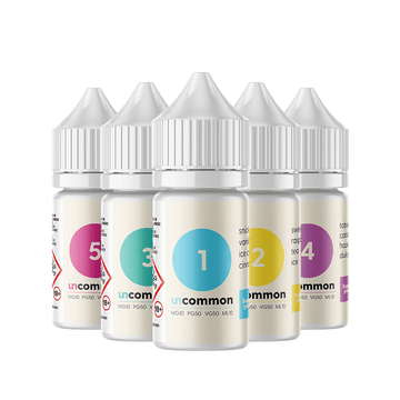 Five bottles of Uncommon vape juice in various flavours with colourful labels.