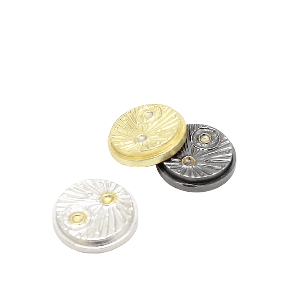 Three textured, round buttons in silver, gold, and black with meteorite designs.