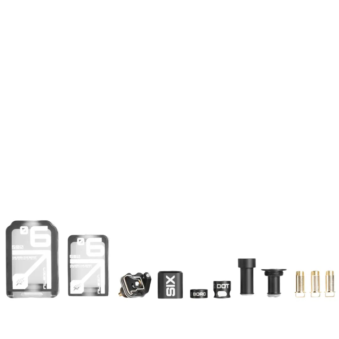 The Six RBA by Alexa contents, including various vape components and accessories, displayed in a row.