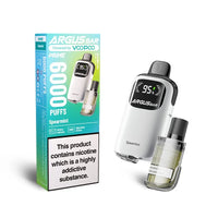 The image displays the Voopoo Argus Bar Prime Disposable Vape Kit in the Spearmint flavour. The packaging highlights its capability to deliver up to 6000 puffs and features a clean white device with a clear digital battery indicator. The pod, attached to the device, is pre-filled and visible in the design. The box also mentions features such as adjustable airflow and a rechargeable battery. A standard warning label is shown at the bottom, stating, "This product contains nicotine which is a highly addictive 